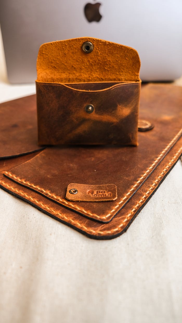 The Art of Drawing Readers In: Your attractive post title goes here Close-up of a vintage brown leather coin purse placed on a white surface, showcasing its elegant design.